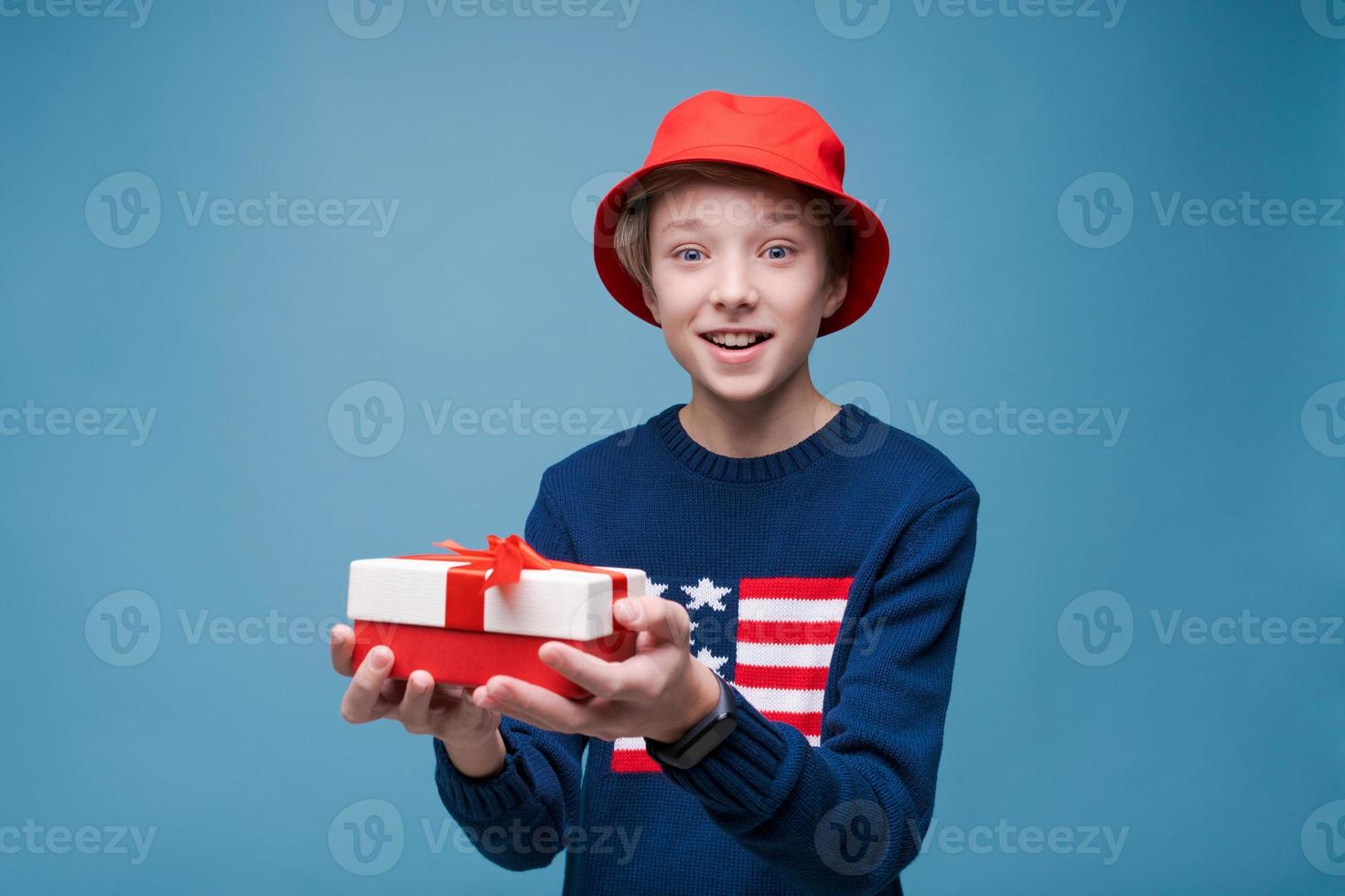 Holidays and celebration concept. Excited young guy receiving a present photo