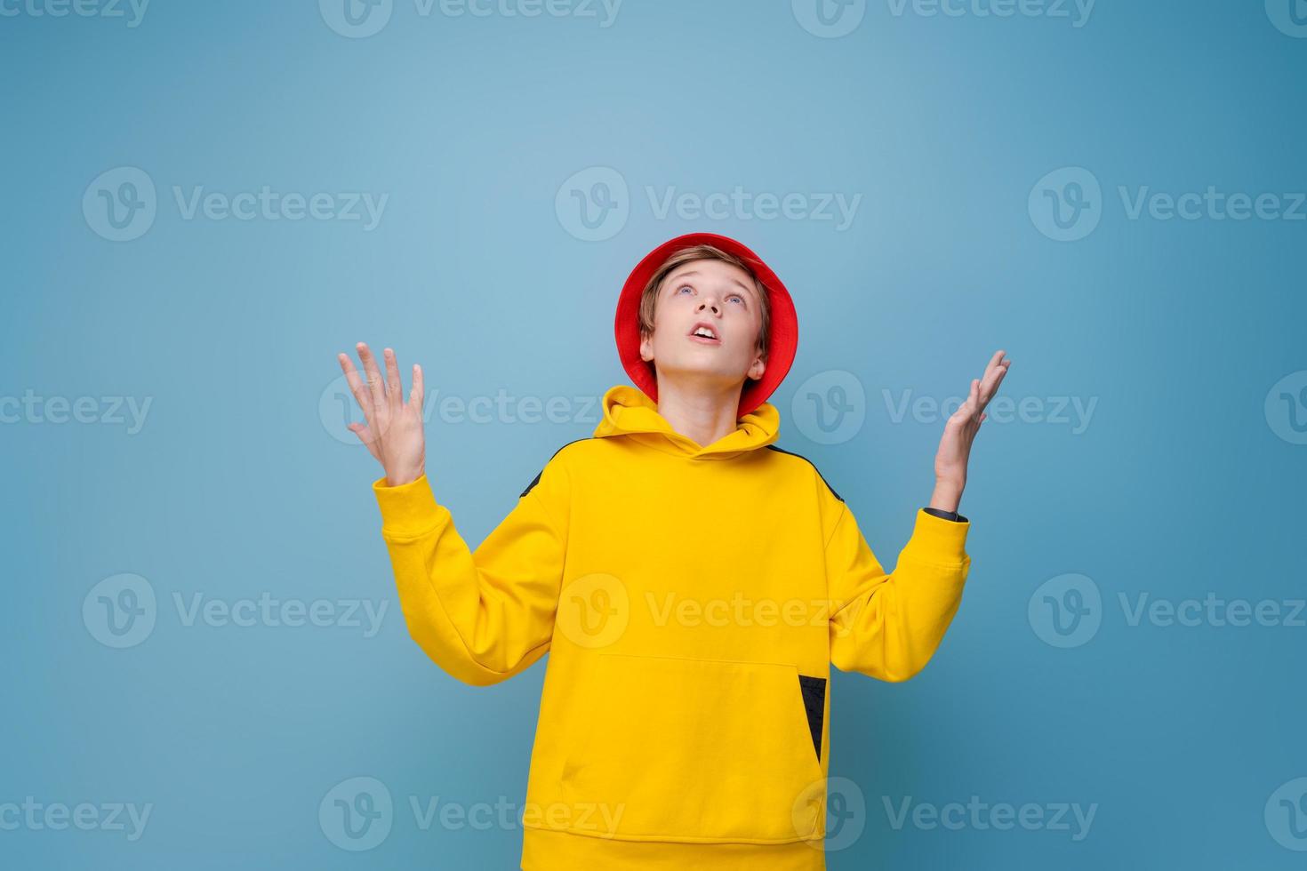 Wow, this is incredible. Shocked caucasian teenager in red hat and yellow photo