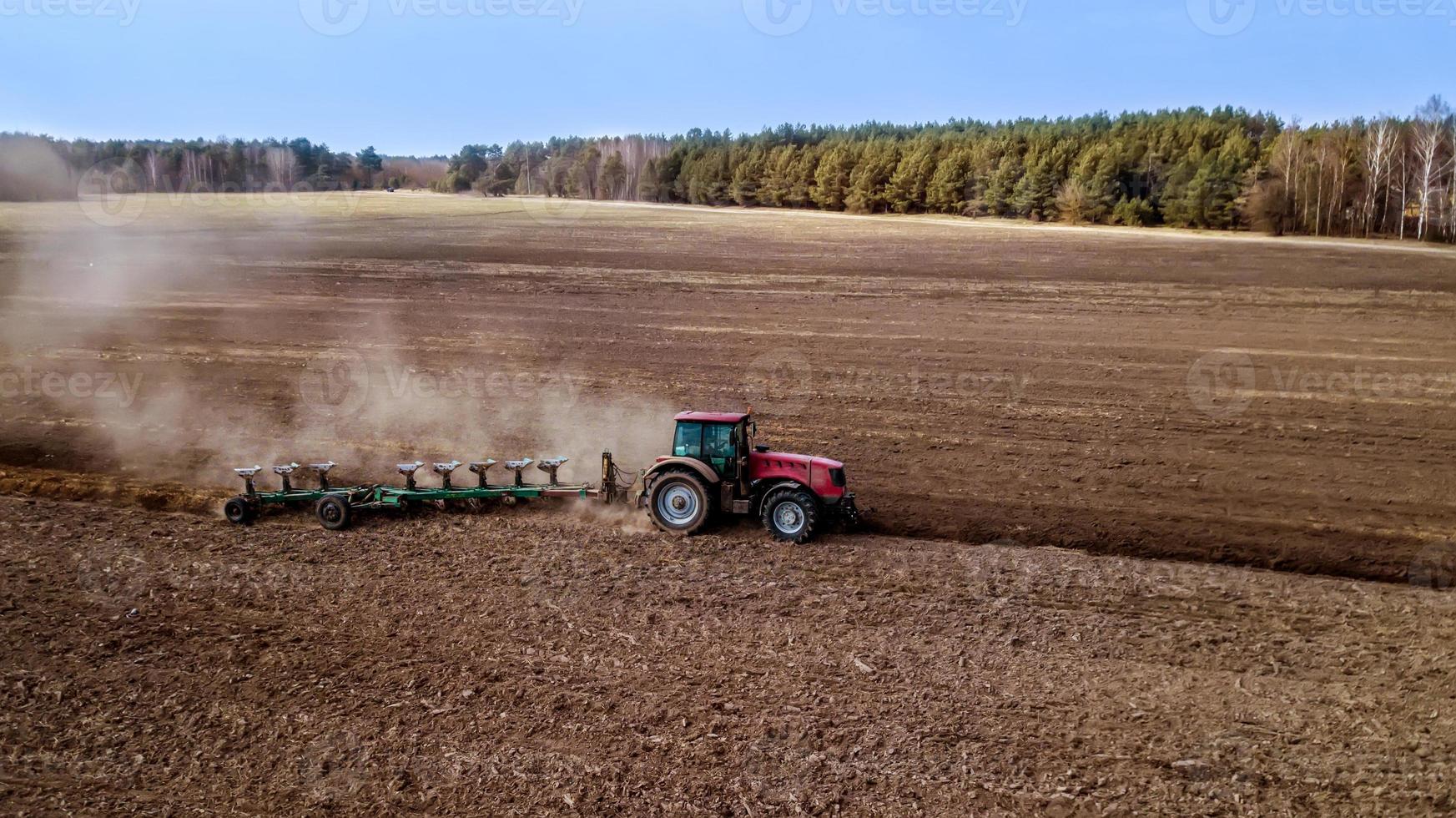 spring plowing field tractor aerial photography with drone photo
