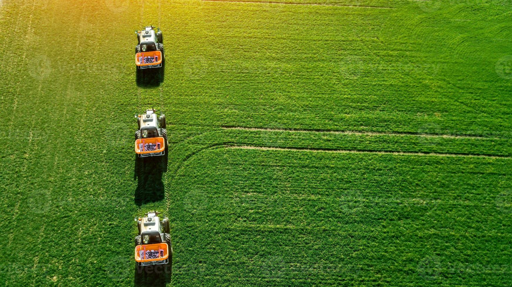 tractor makes fertilizer on the field. Top view photo