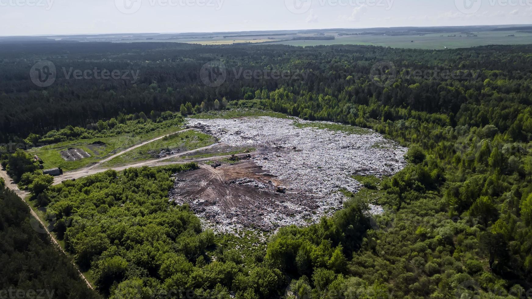 landfill removal of unsorted debris in the middle of the forest. Aerial photography with drone photo