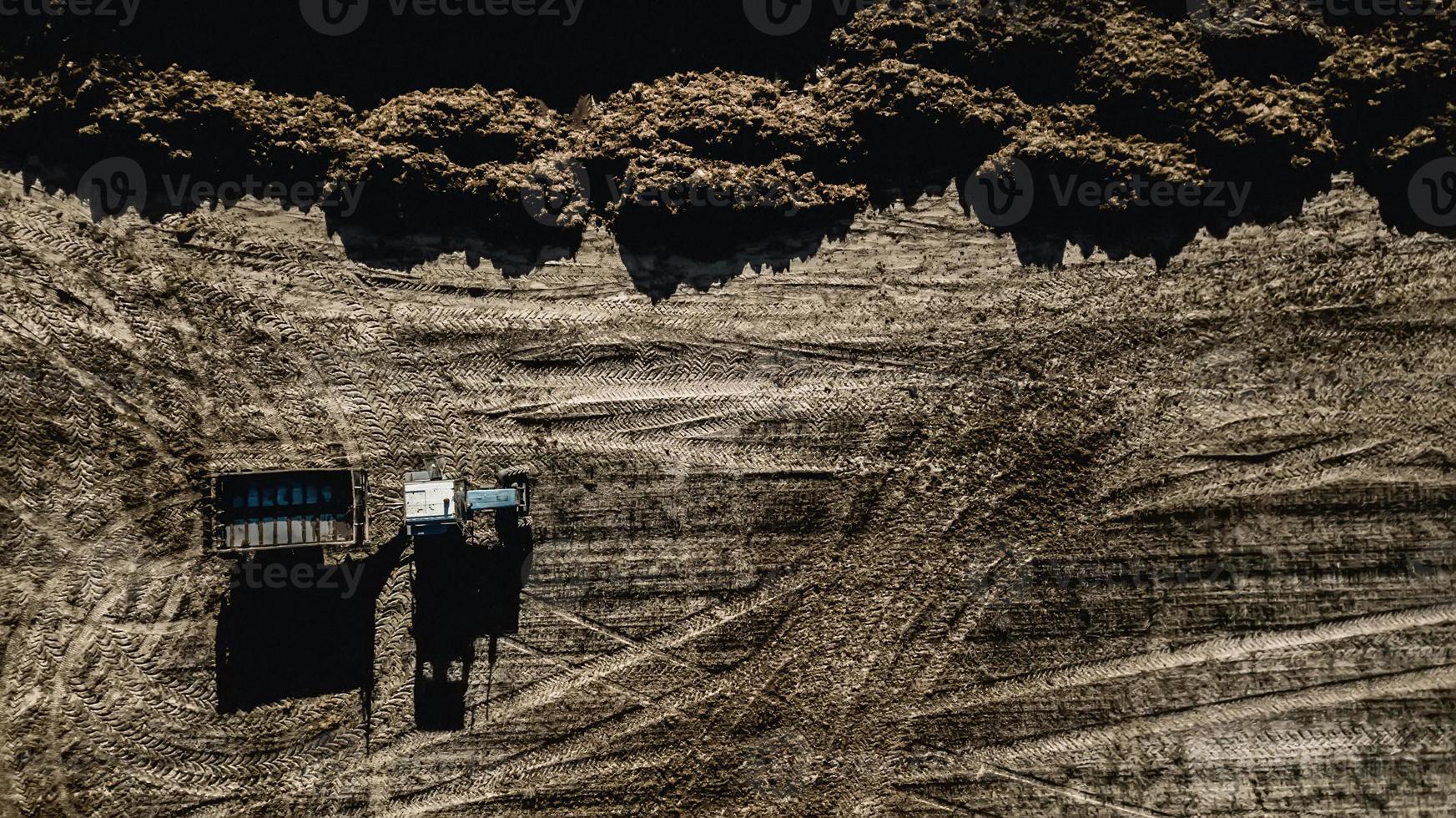 Tractor in the field. Aerial survey. Fertilization photo