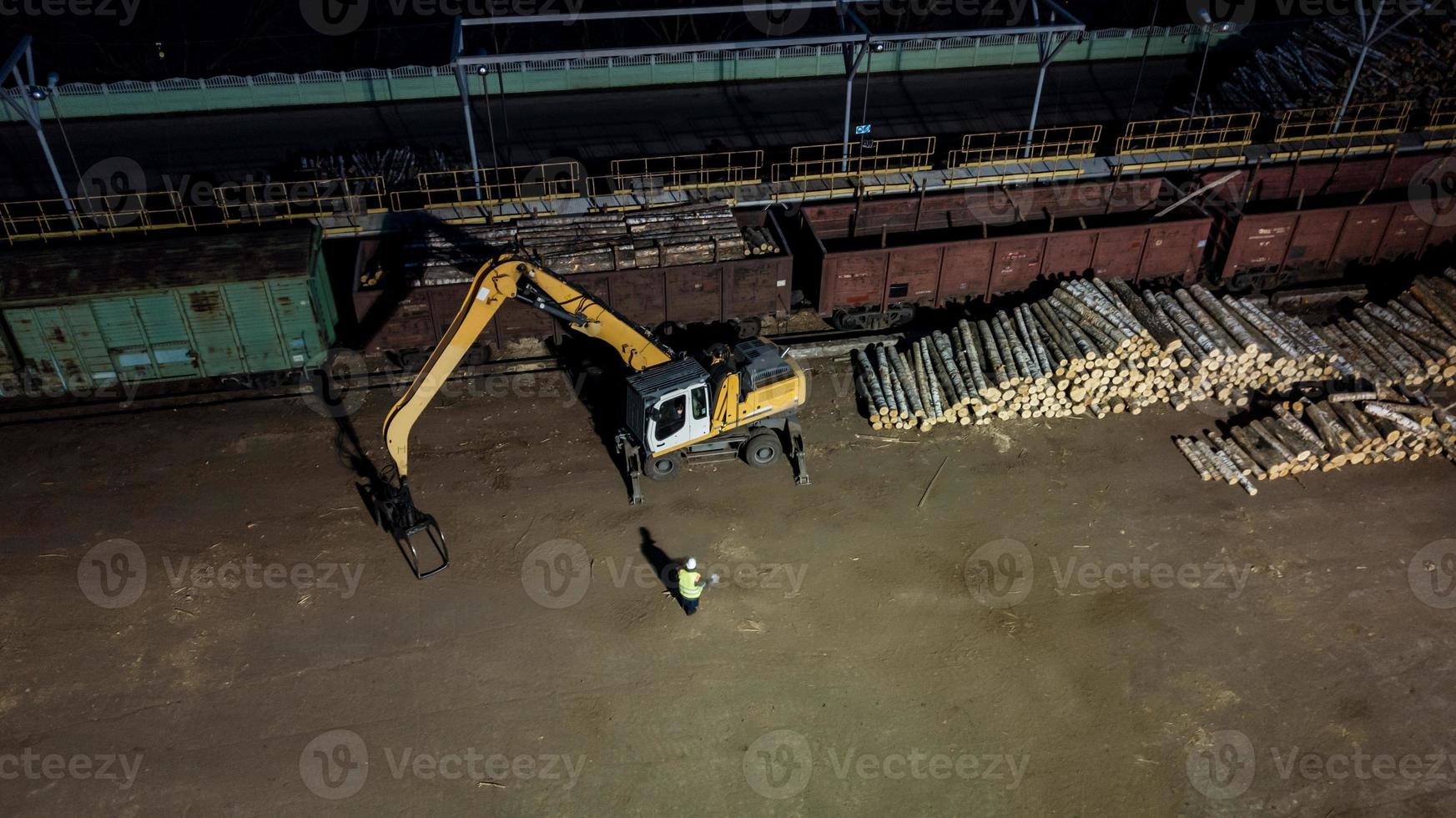 Woodworking factory. Loading the forest in the truck. Night aerial photography photo