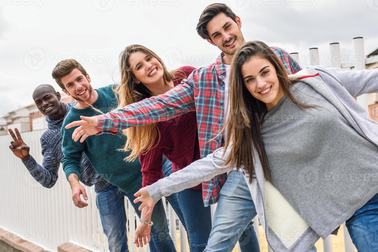 Group of friends having fun together outdoors photo