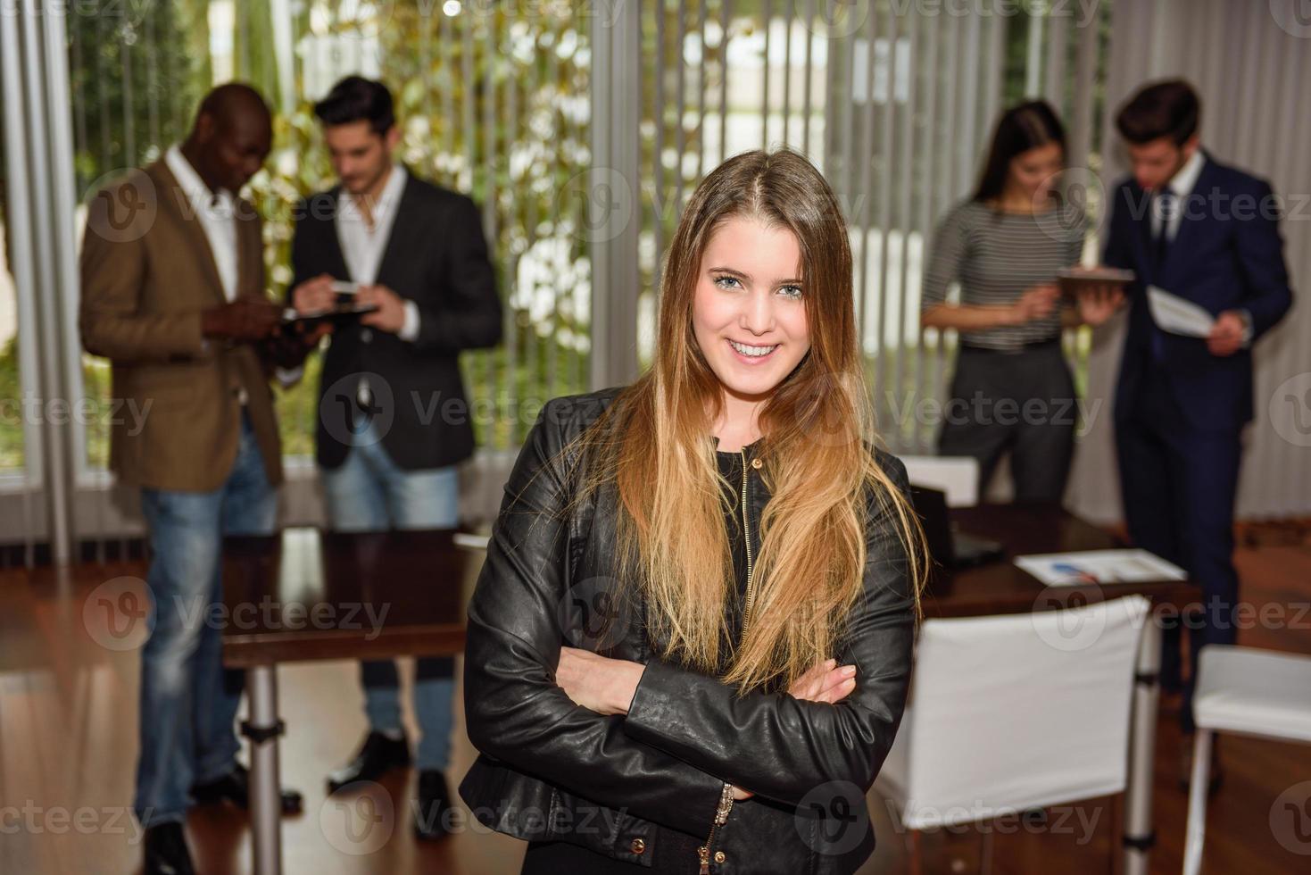 Businesswoman leader looking at camera in working environment. photo