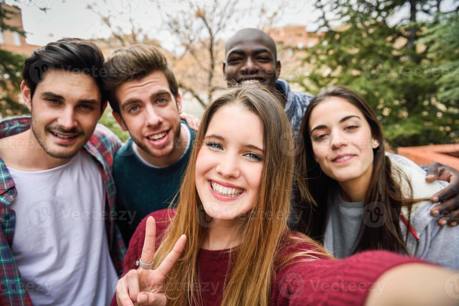 Multiracial group of friends taking selfie photo