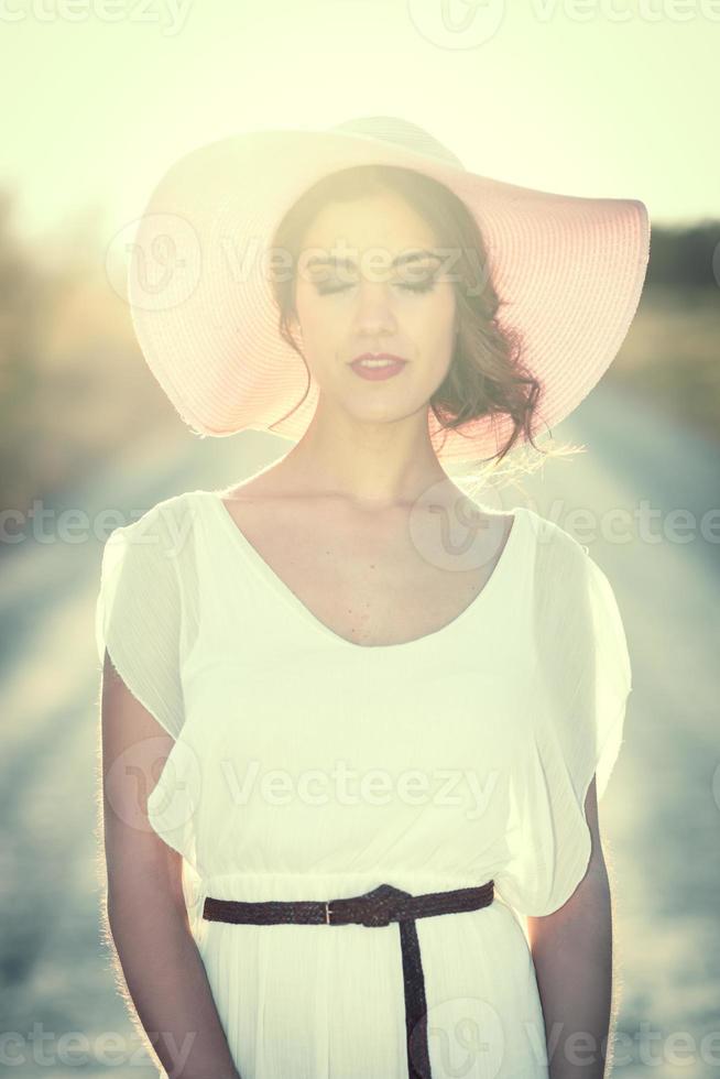 Portrait of young woman in the flowered garden in the spring time photo