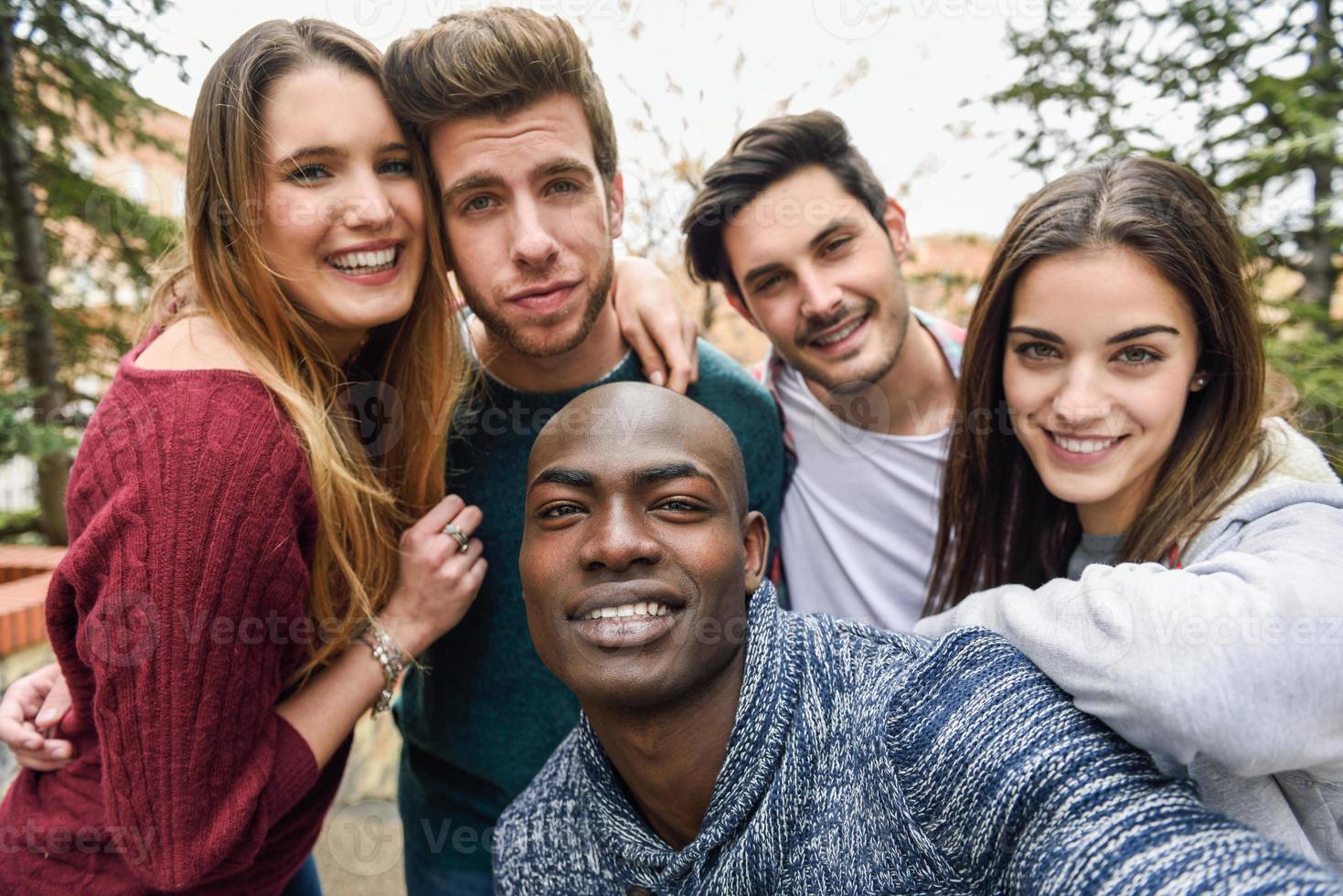 Multiracial group of friends taking selfie photo