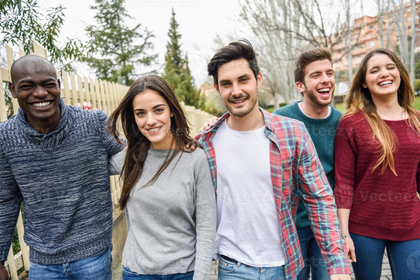 Group of friends having fun together outdoors photo