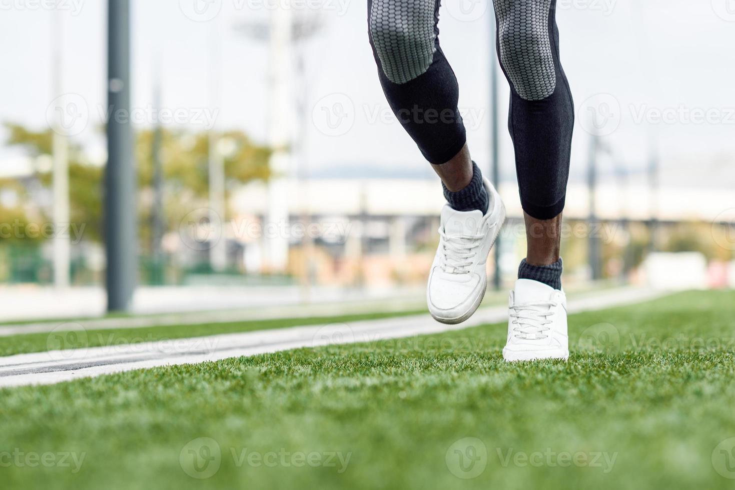 Attractive black man running in urban background photo