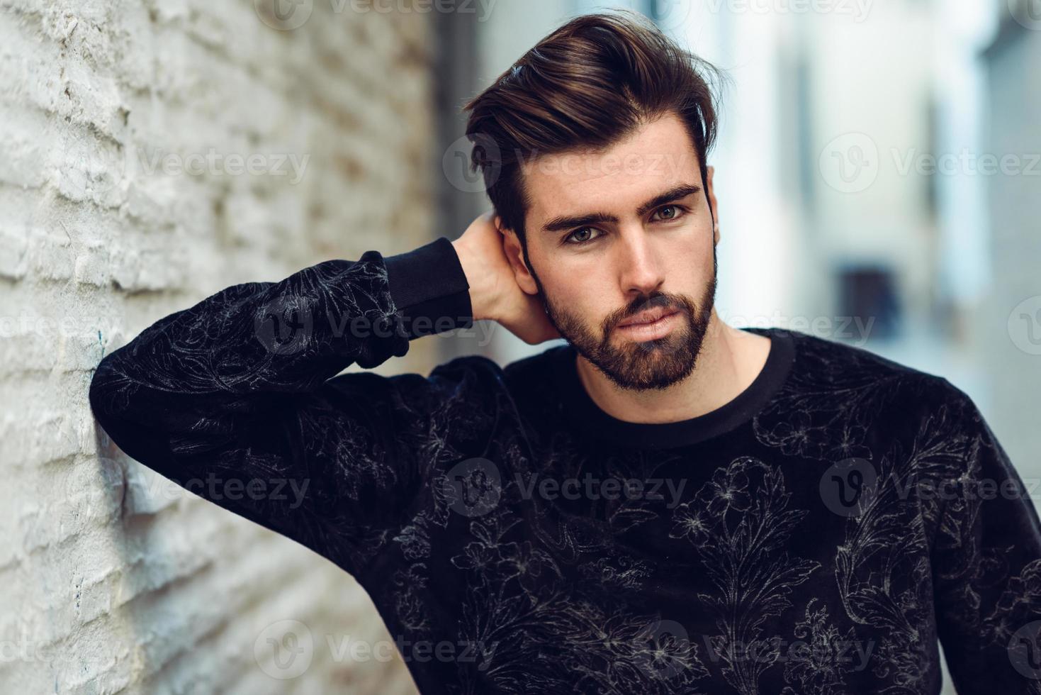 Young bearded man, model of fashion, in urban background wearing casual clothes. photo