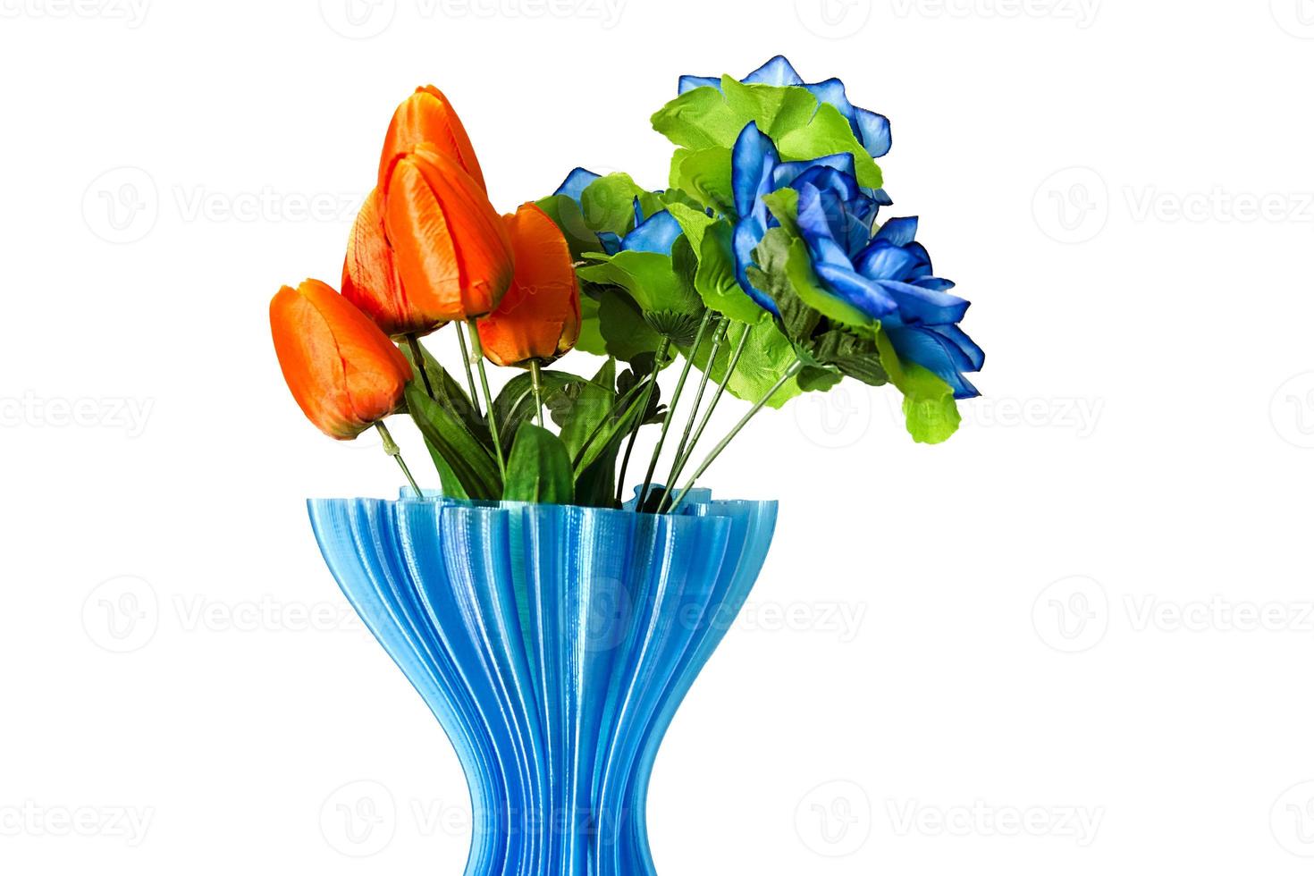 A bouquet of tulips in a little blue vase photo