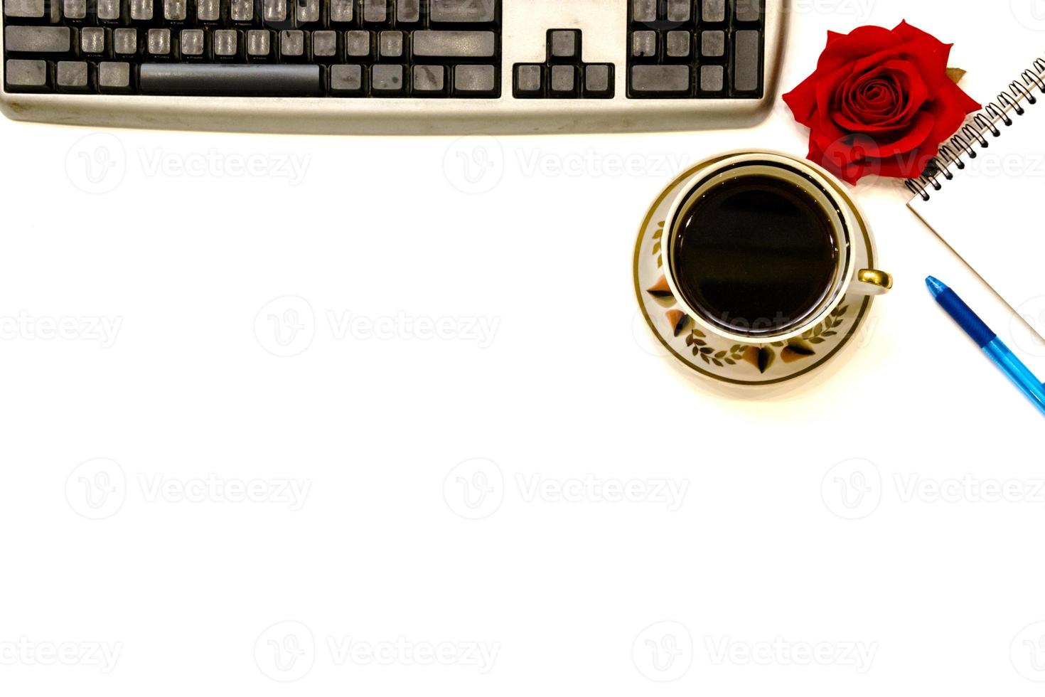 Cup of coffe and open notebook on white background photo