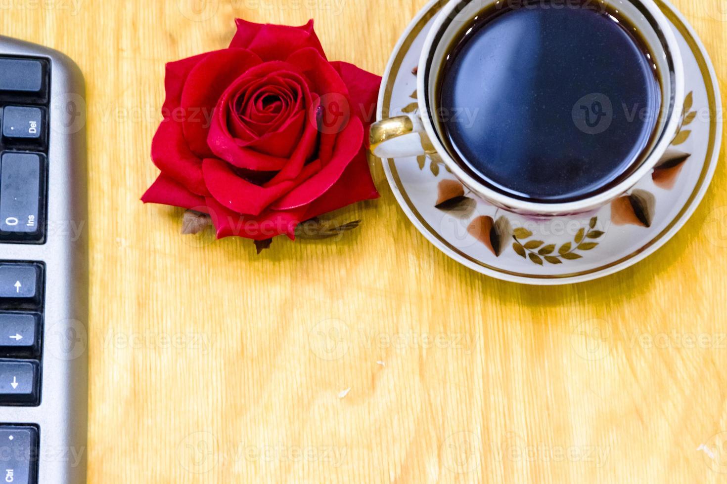 Cup of coffe and open notebook on wooden background photo