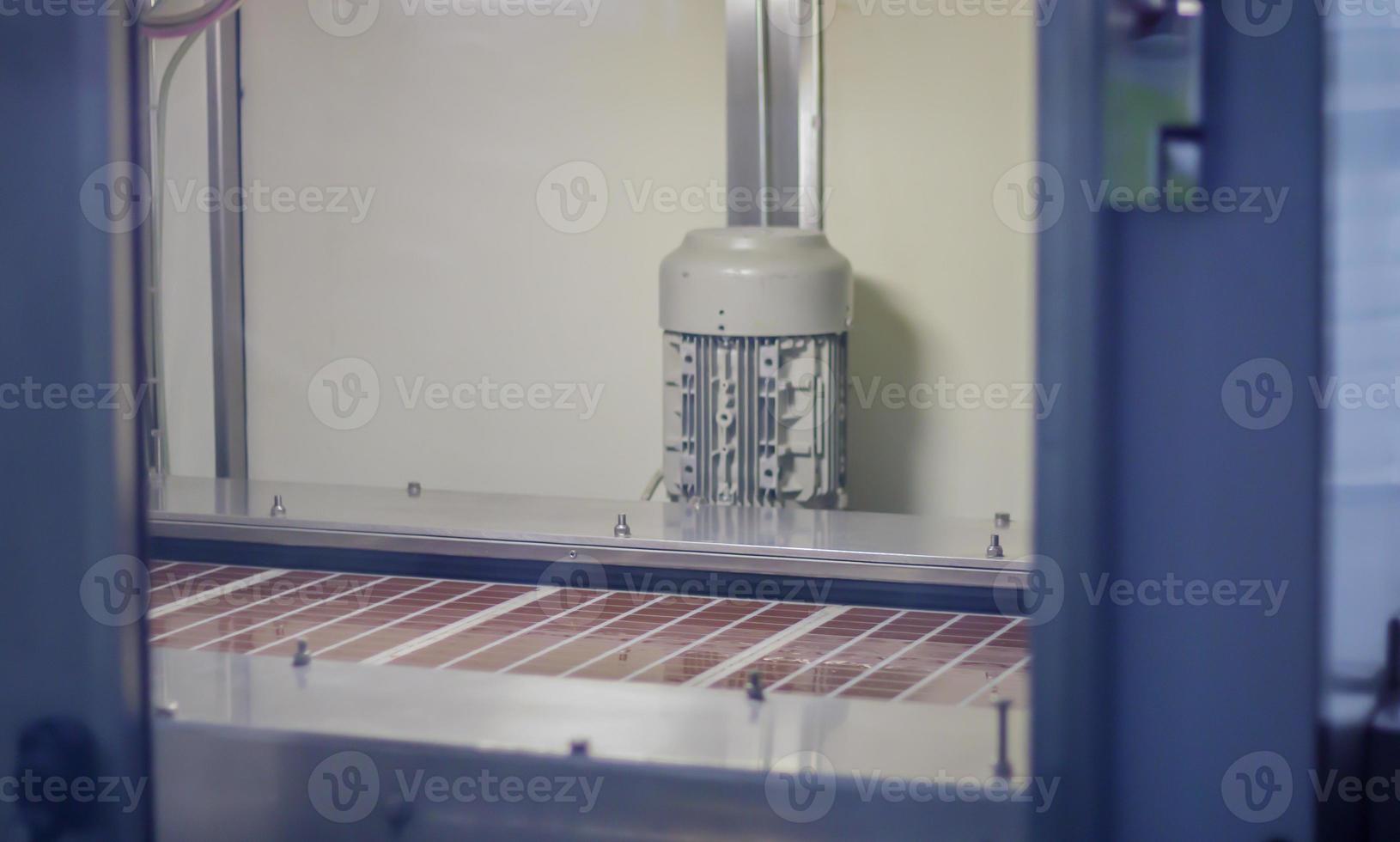 Line for the production of chocolate in an industrial factory. Automatic process in the production line of sweets. Images from the chocolate factory during production. Conveyor belt with sweets. photo