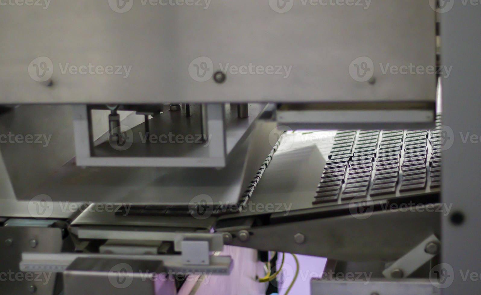 Factory for the production of sweets and chocolate. Automatic line for the production of chocolate in an industrial factory. Conveyor belt with sweets. Sweets production process. Food industry. photo