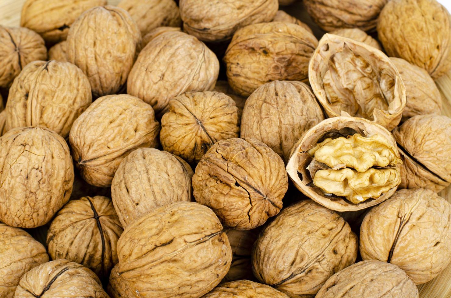 tasty Unpeeled walnuts, background, texture. Studio Photo