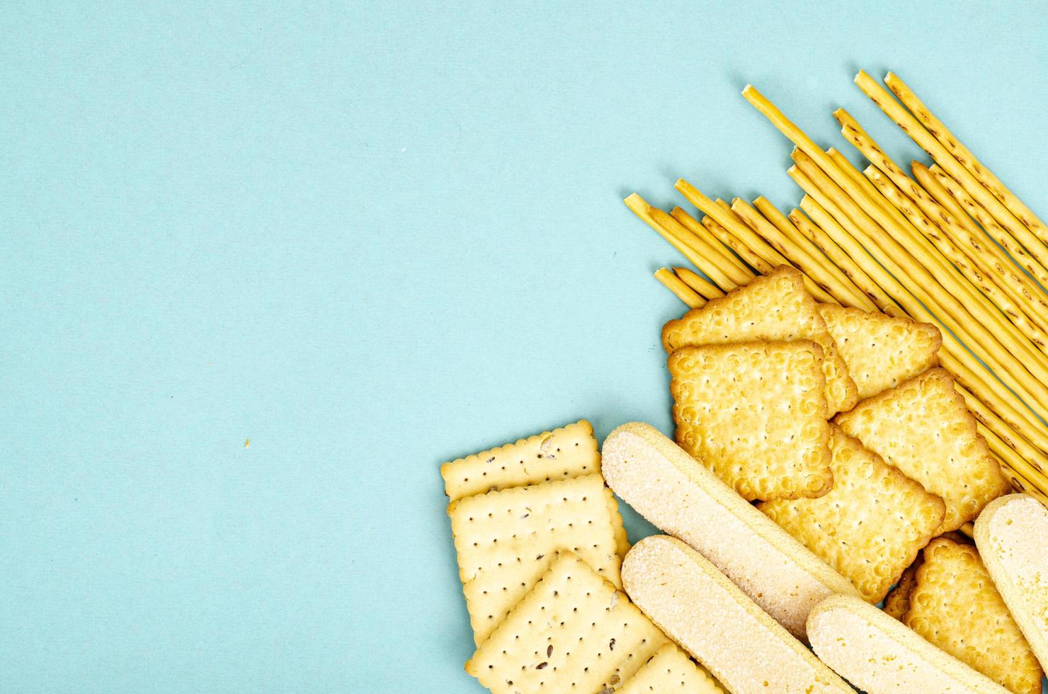 Delicious sweet and savory cookies on blue background. Studio Photo