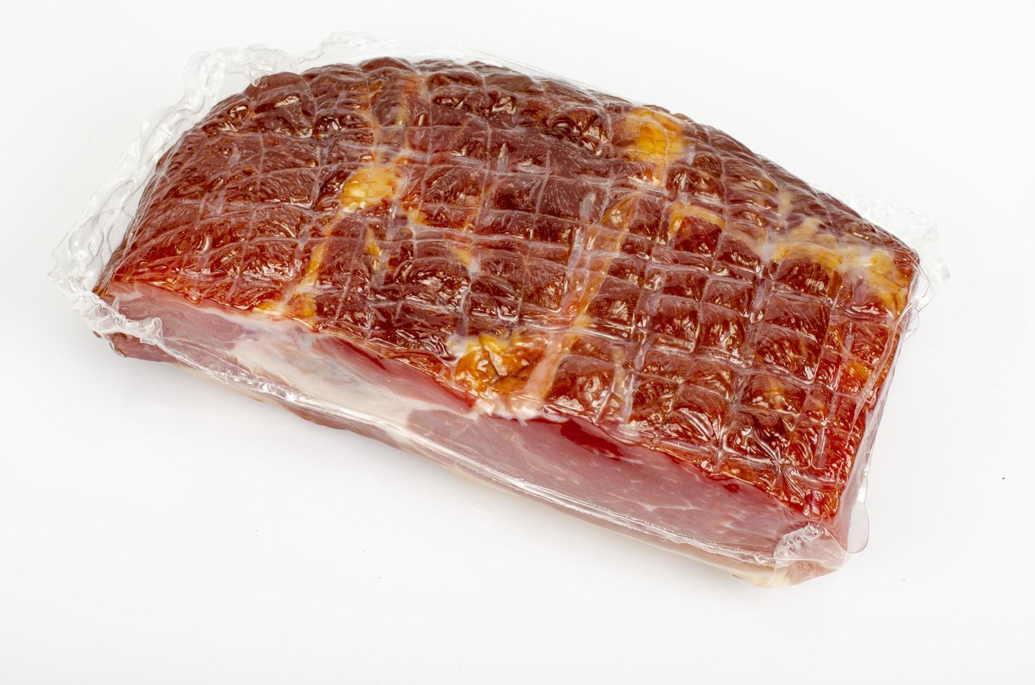 Piece of raw smoked pork ham on white background. Studio Photo