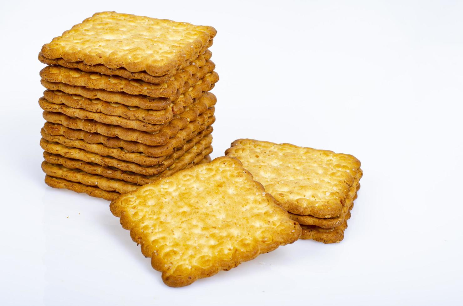 Minimalist pile delicious cookies. Salty biscuit cracker on white background. Studio Photo