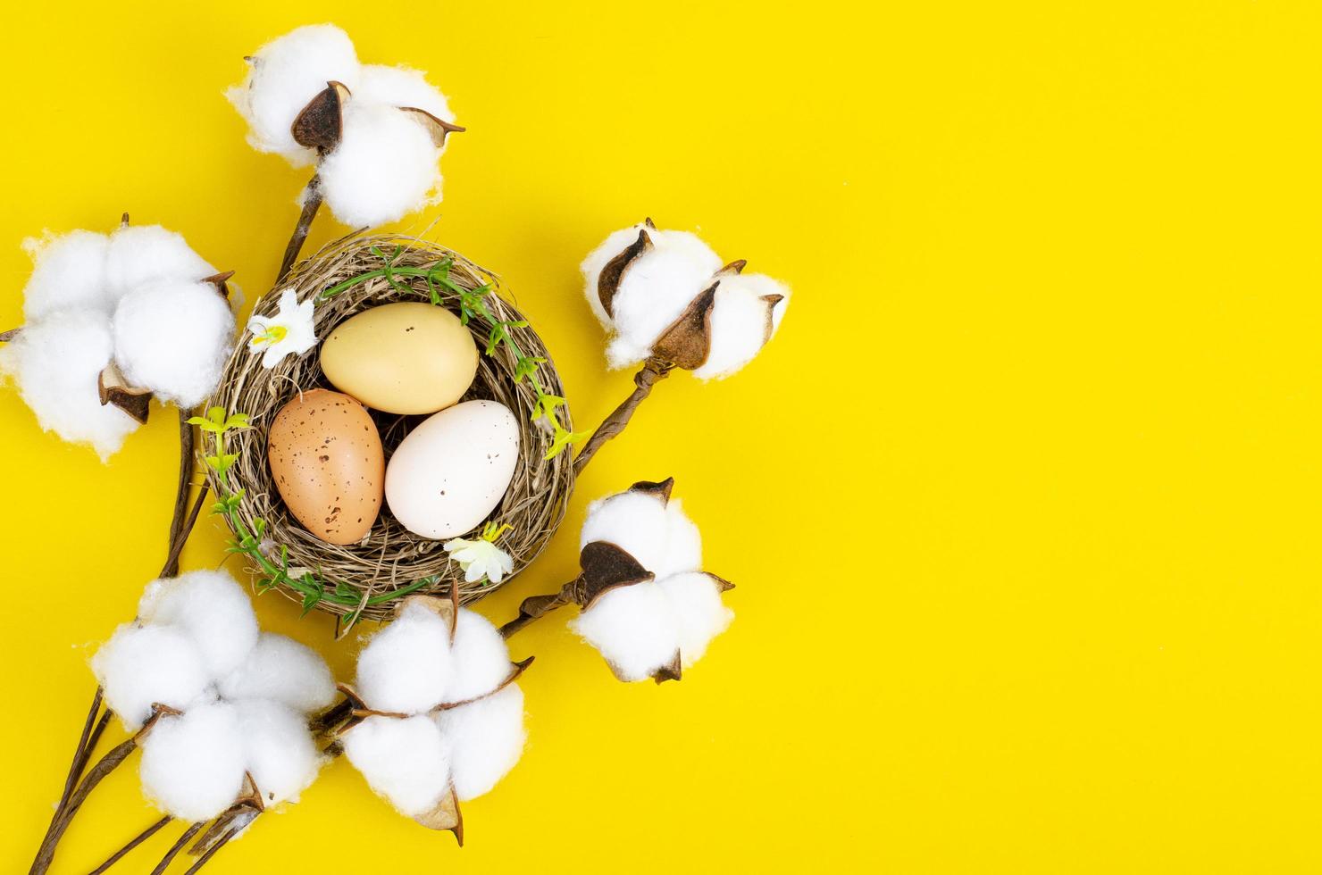 Top view of color easter haqndmade eggs and nest flatlay. Trendy minimal design spring background. Space for text. Stuio Photo