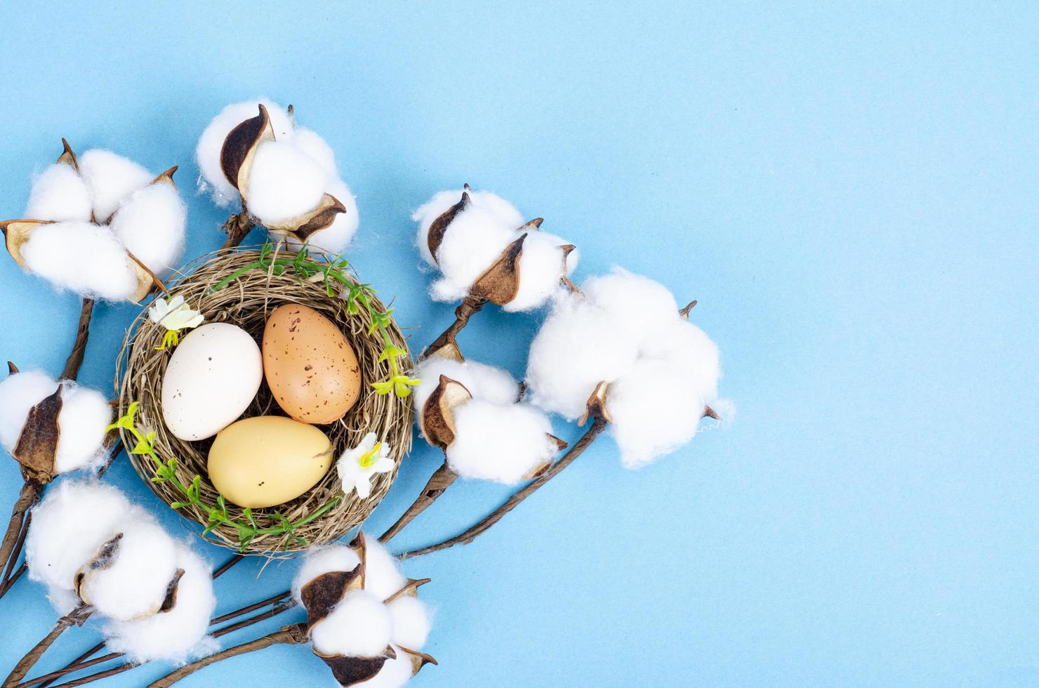 Top view of color easter haqndmade eggs and nest flatlay. Trendy minimal design spring background. Space for text. Stuio Photo