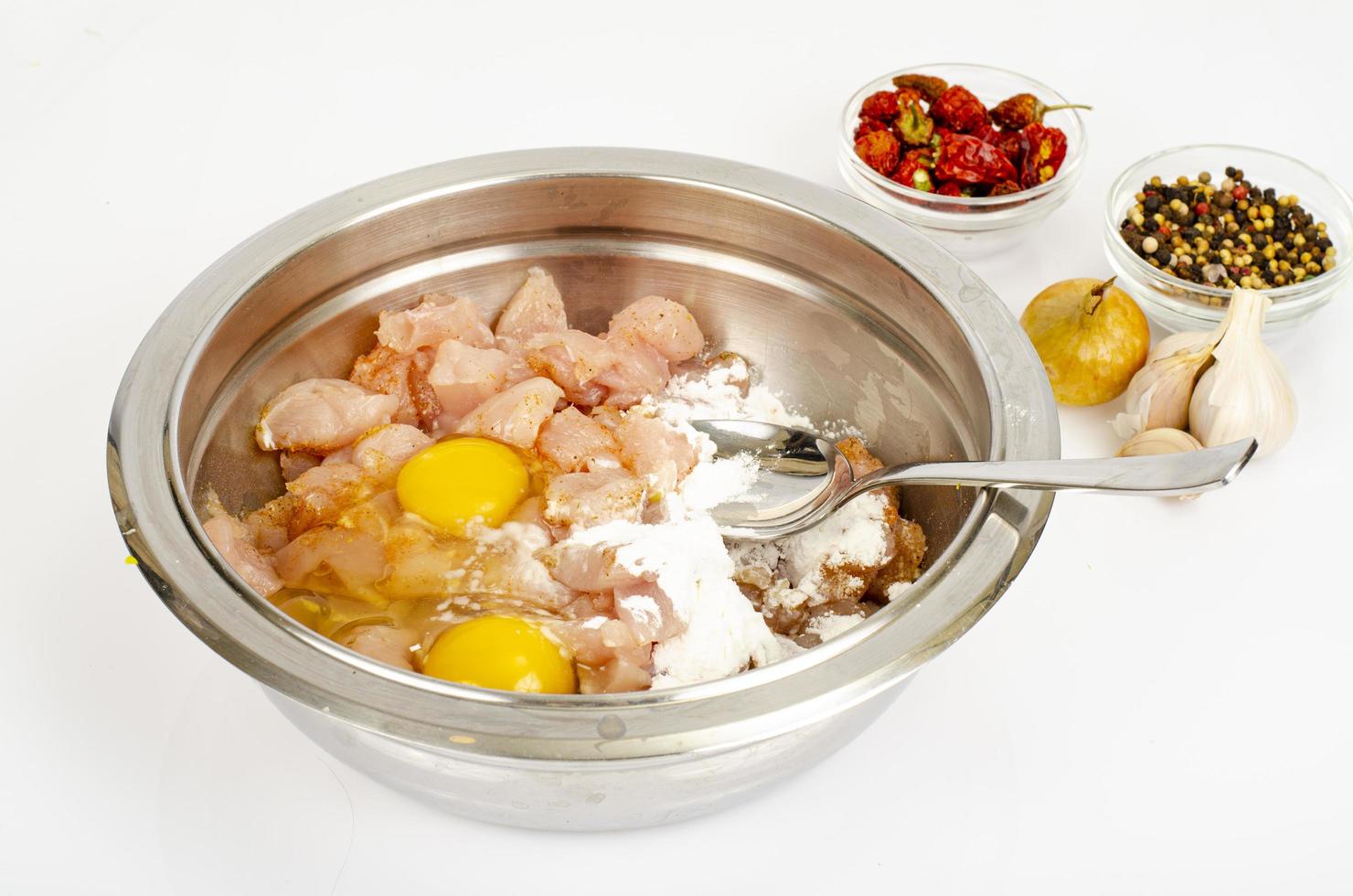 Pieces of chicken fillet, raw eggs, spices for cooking. Studio Photo