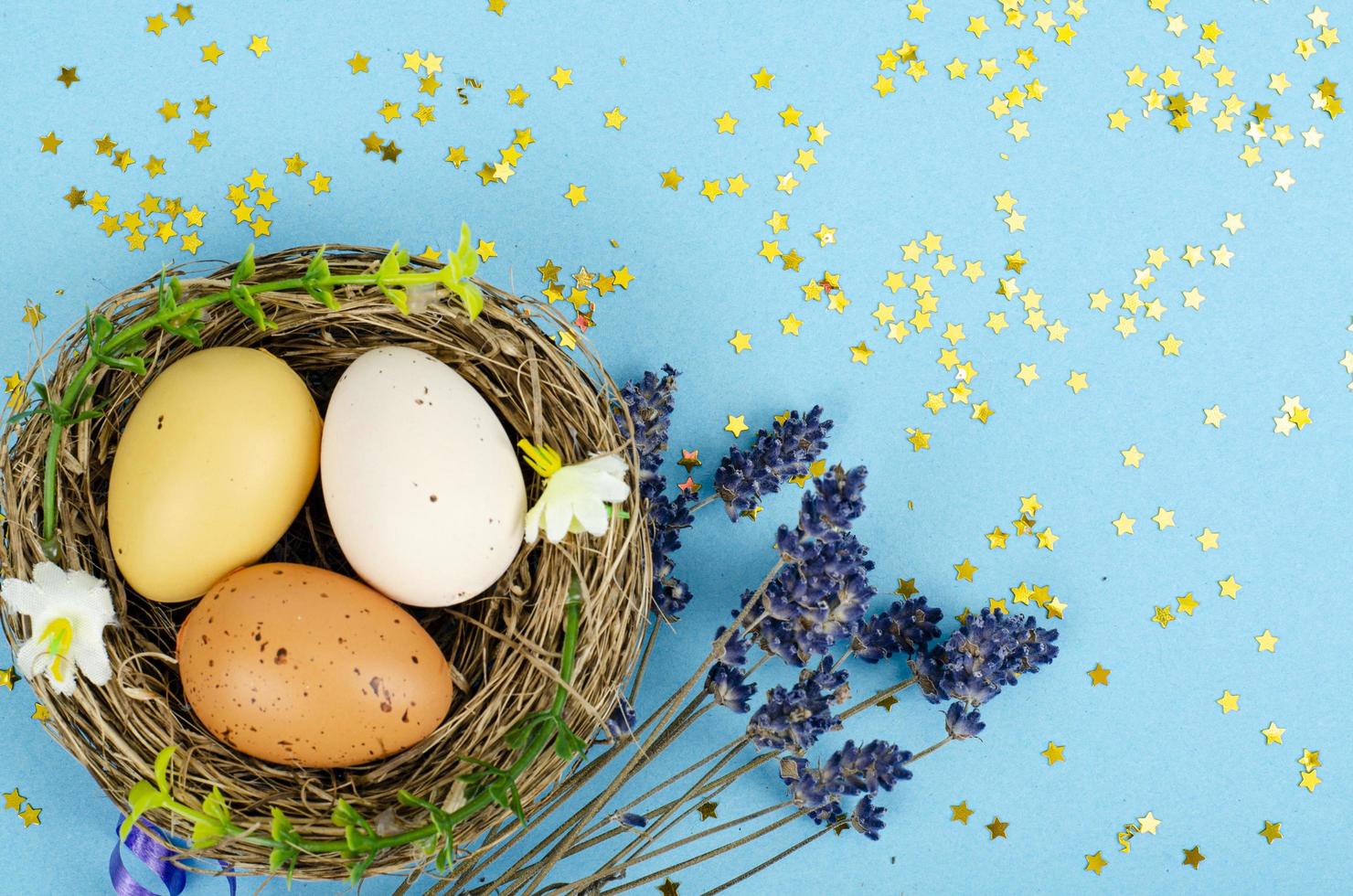 Decorated handmade Easter eggs for the holiday season on blue background. Creative minimal abstract concept. Studio Photo