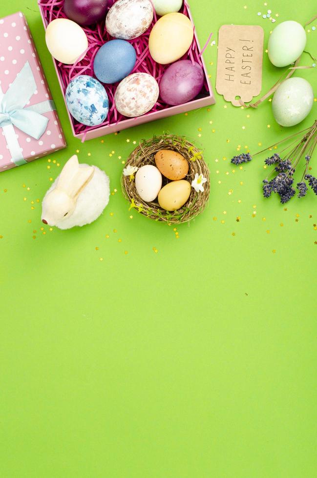 Multicolored eggs in open gift box. Concept of the Happy Easter holiday, greeting card template. Studio Photo