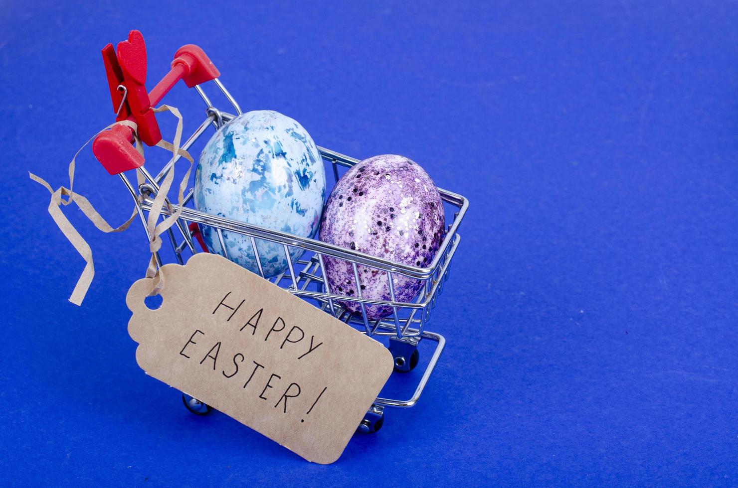 Grocery supermarket cart filled with chicken eggs. Concept of preparing for Easter, buying food. Space for text. Studio Photo