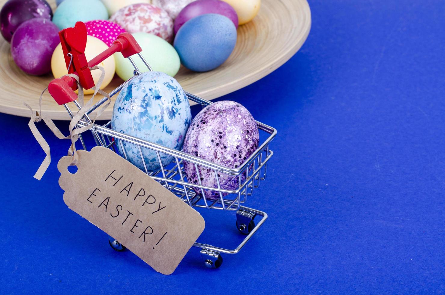 Grocery supermarket cart filled with chicken eggs. Concept of preparing for Easter, buying food. Space for text. Studio Photo