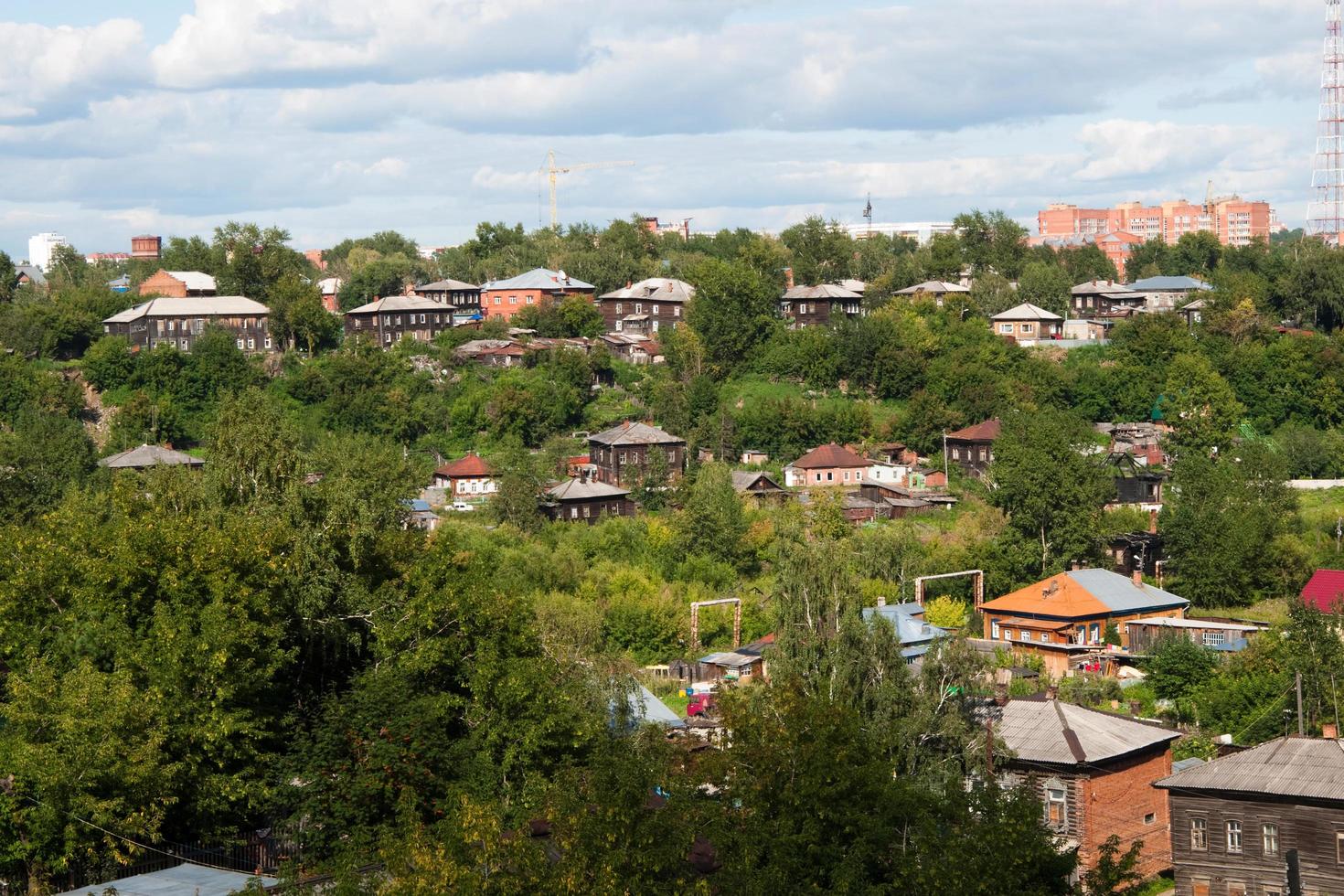 Beautiful view of Tomsk, a picturesque town in Siberia. Wooden houses and green area. Russia photo