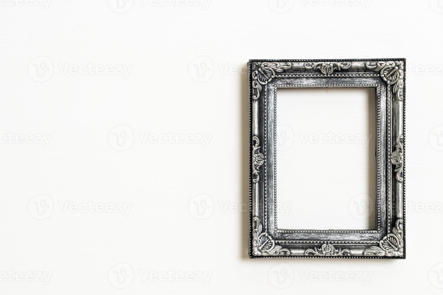 empty picture frame on white wall background photo