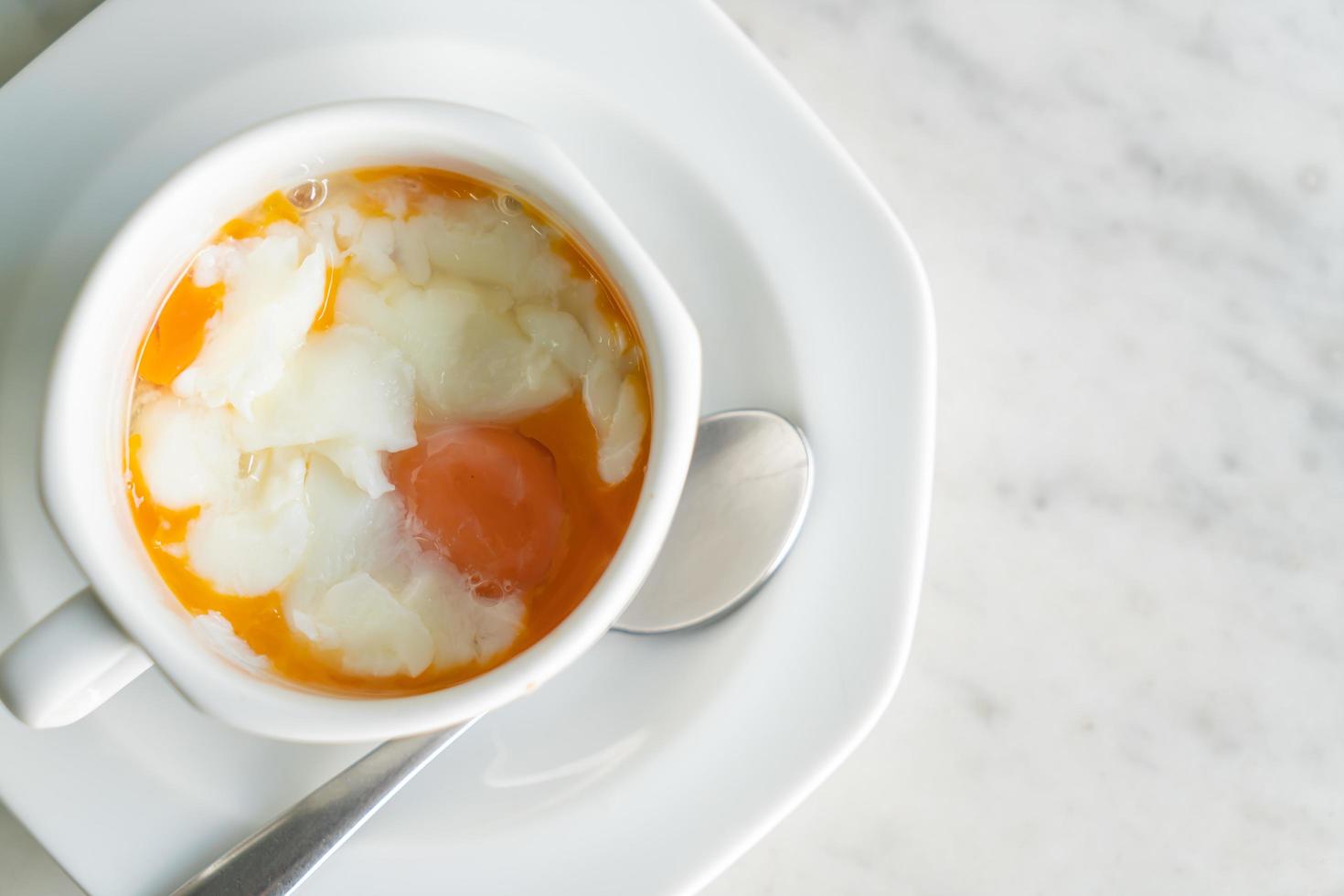 Soft-boiled eggs in white cup photo