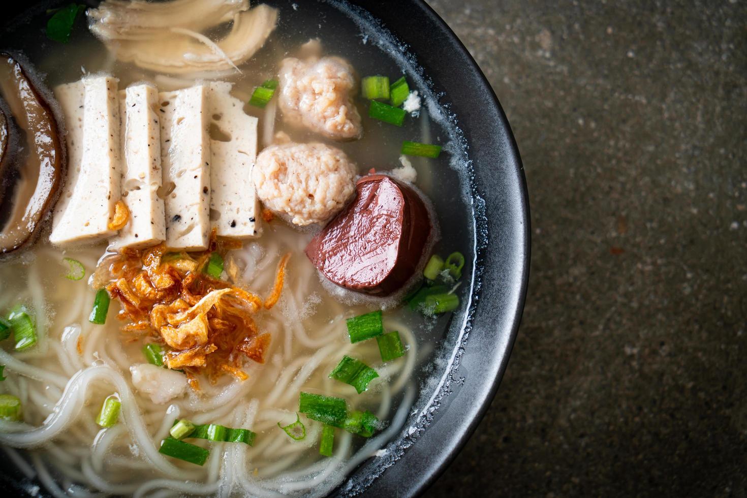 Vietnamese Rice Noodles Soup with Vietnamese Sausage served vegetables and crispy onion photo