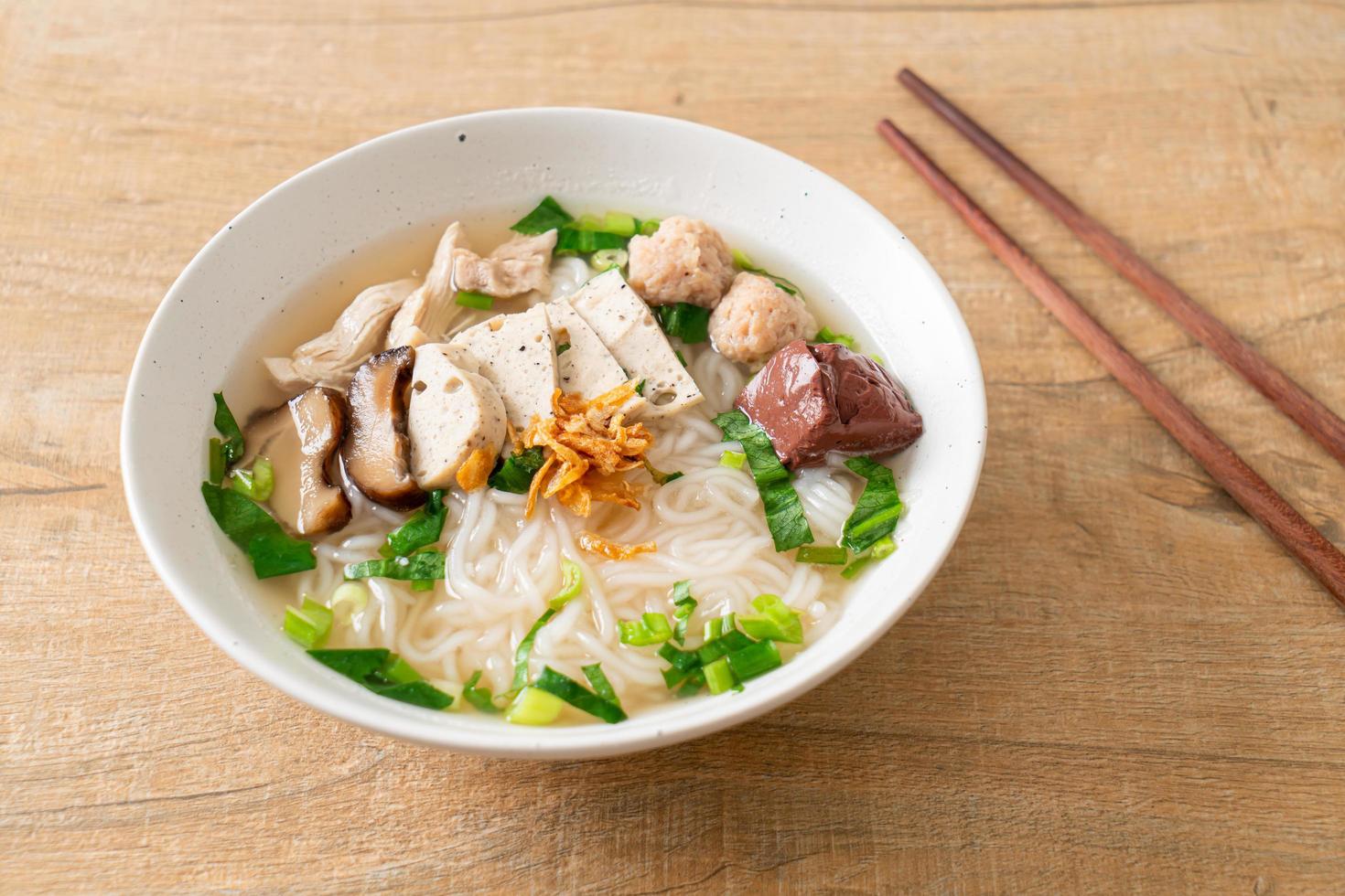 Vietnamese Rice Noodles Soup with Vietnamese Sausage served vegetables and crispy onion photo