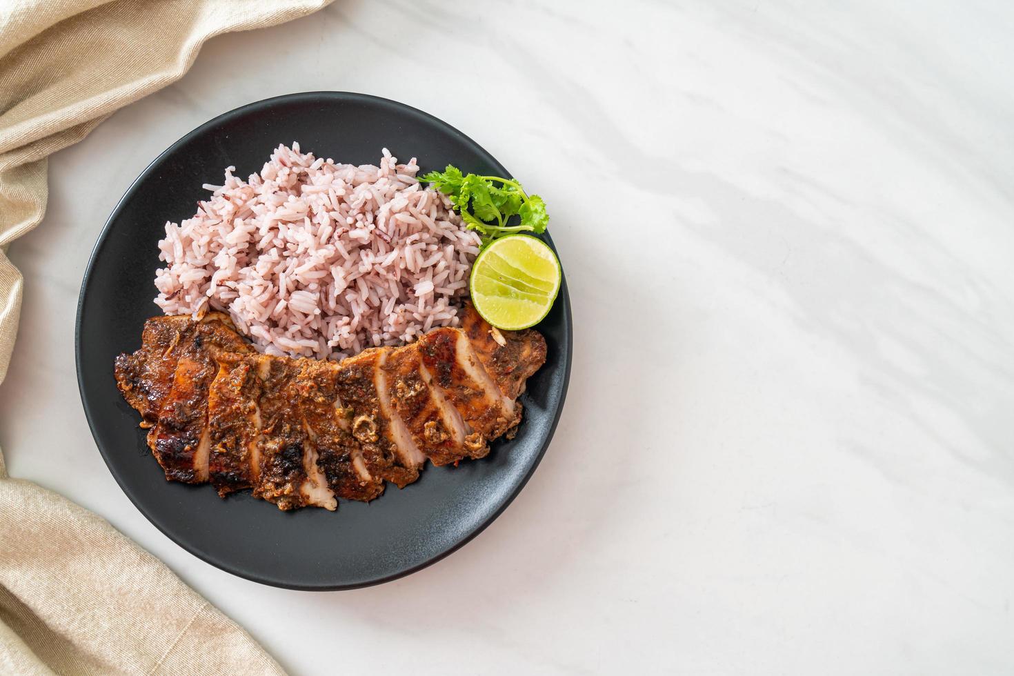 spicy grilled Jamaican jerk chicken with rice photo