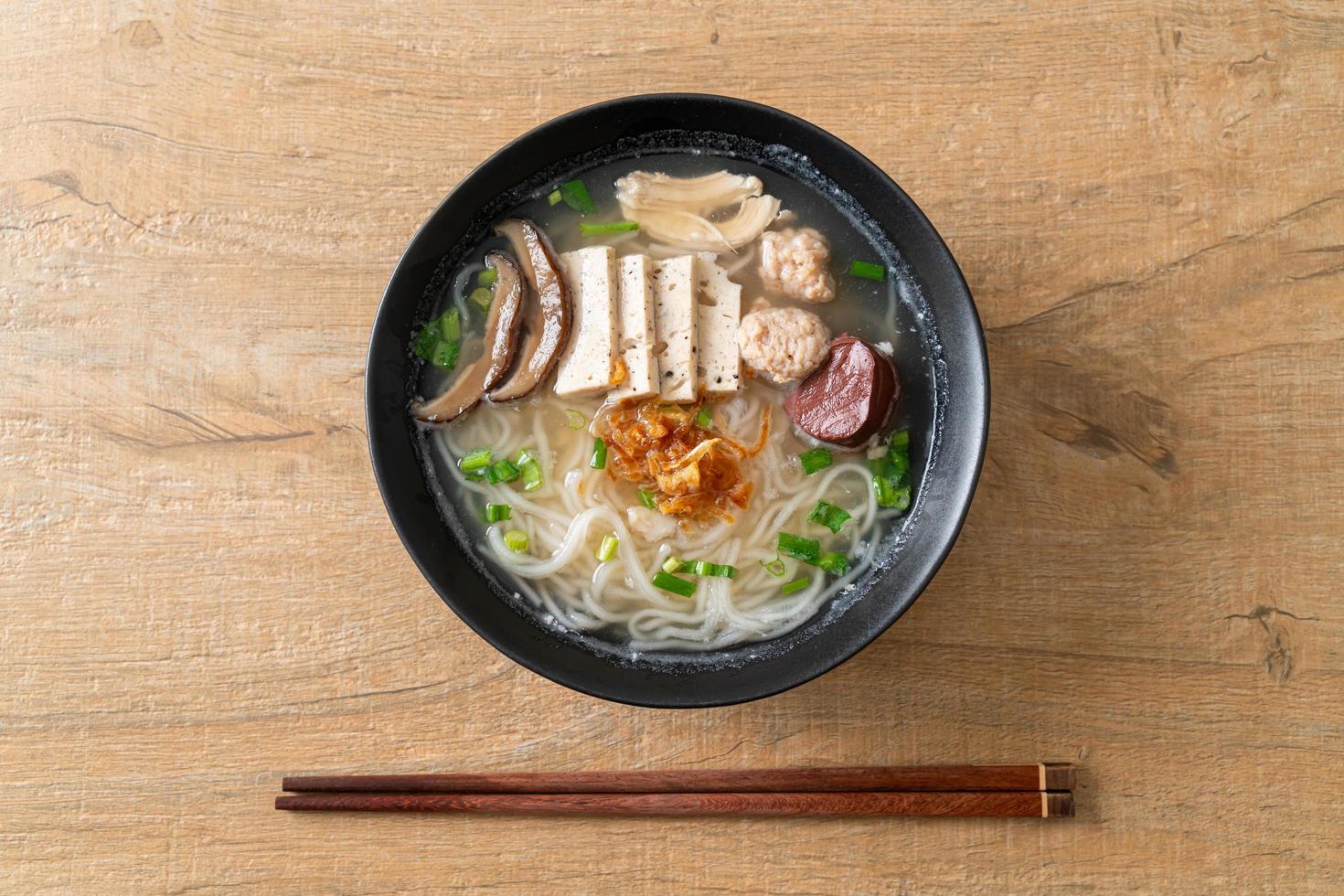 Vietnamese Rice Noodles Soup with Vietnamese Sausage served vegetables and crispy onion photo