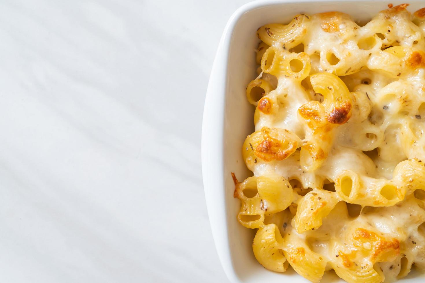 American mac and cheese, macaroni pasta in cheesy sauce photo