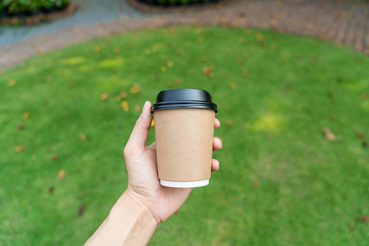 hand holding hot coffee glass photo