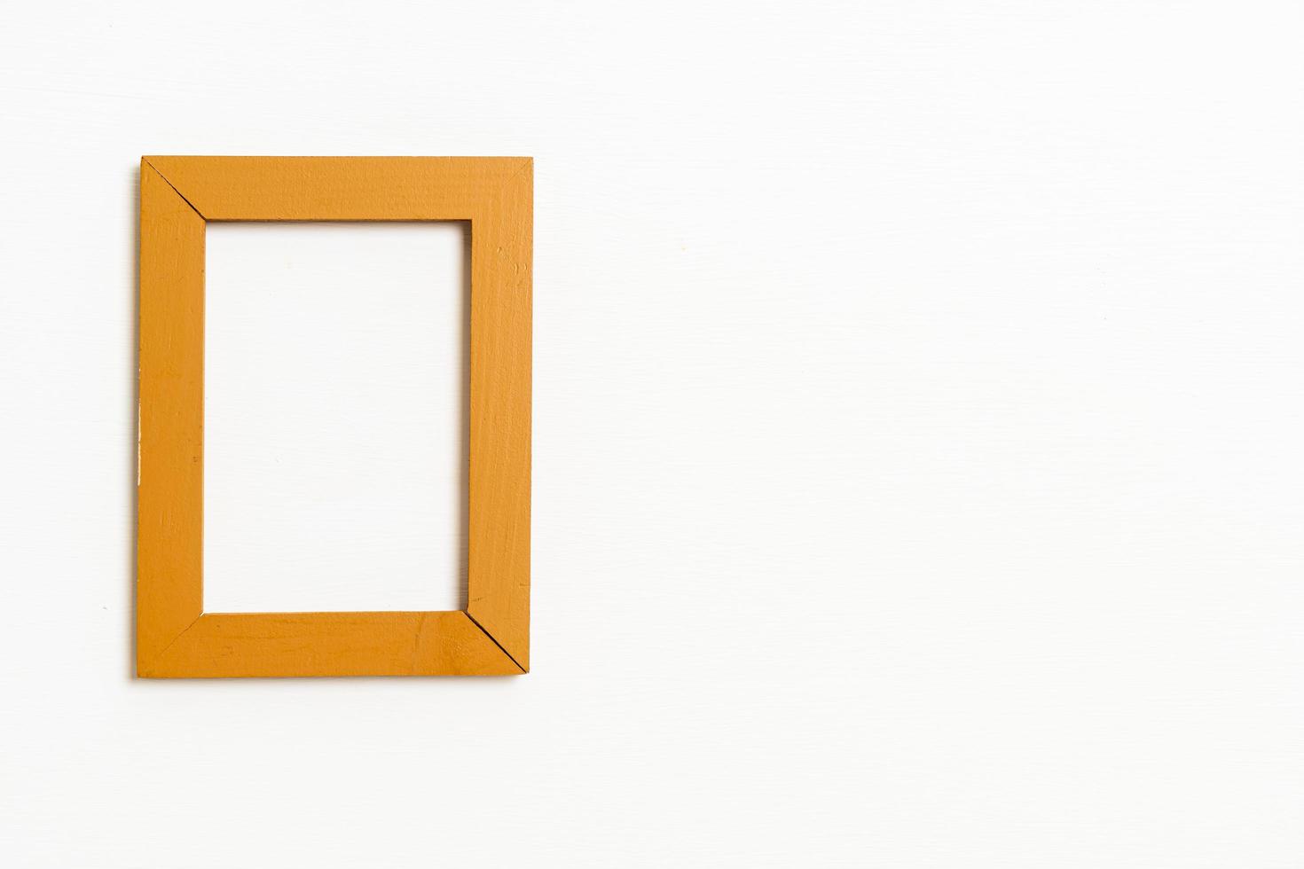 empty picture frame on white wall background photo