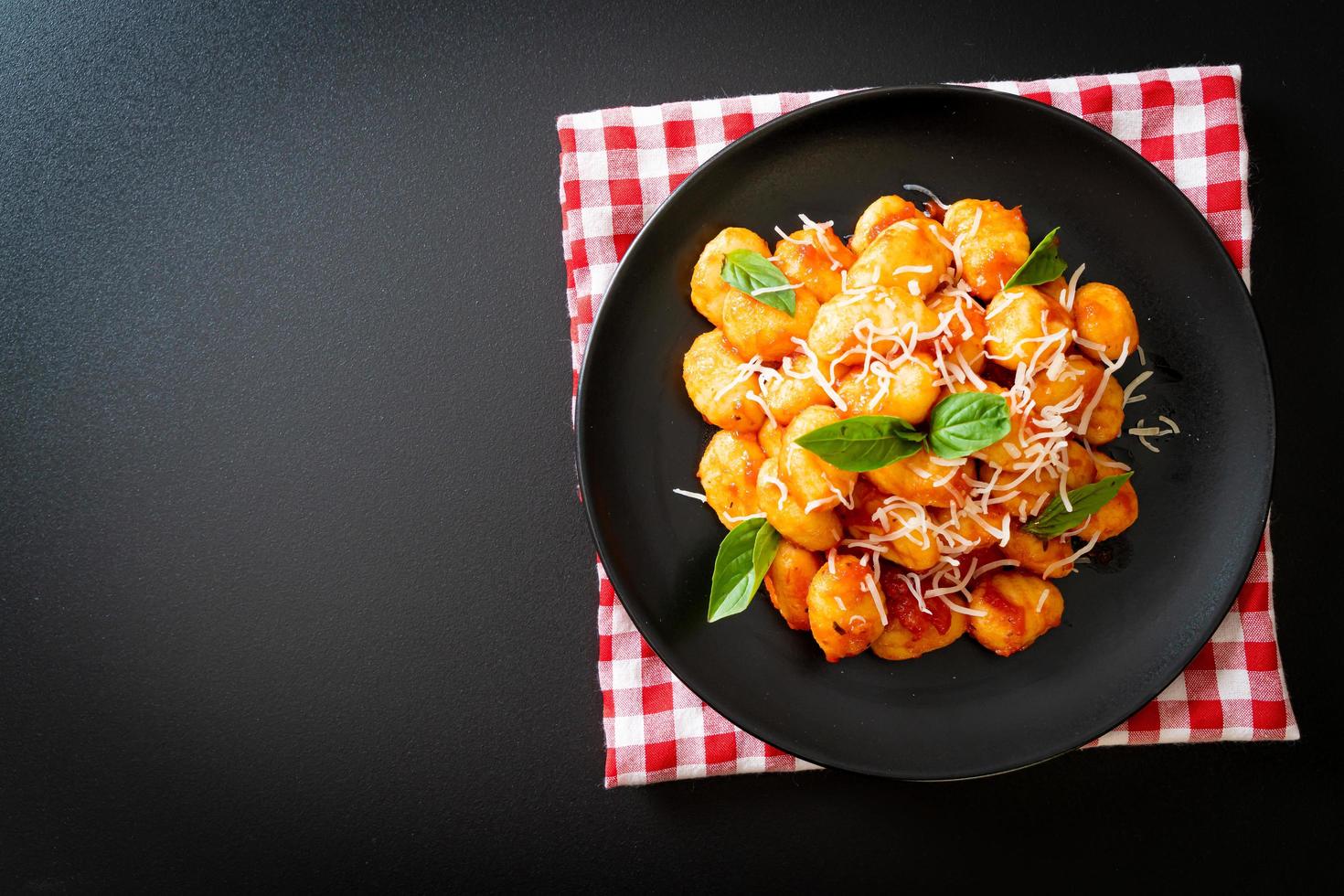 gnocchi in tomato sauce with cheese photo