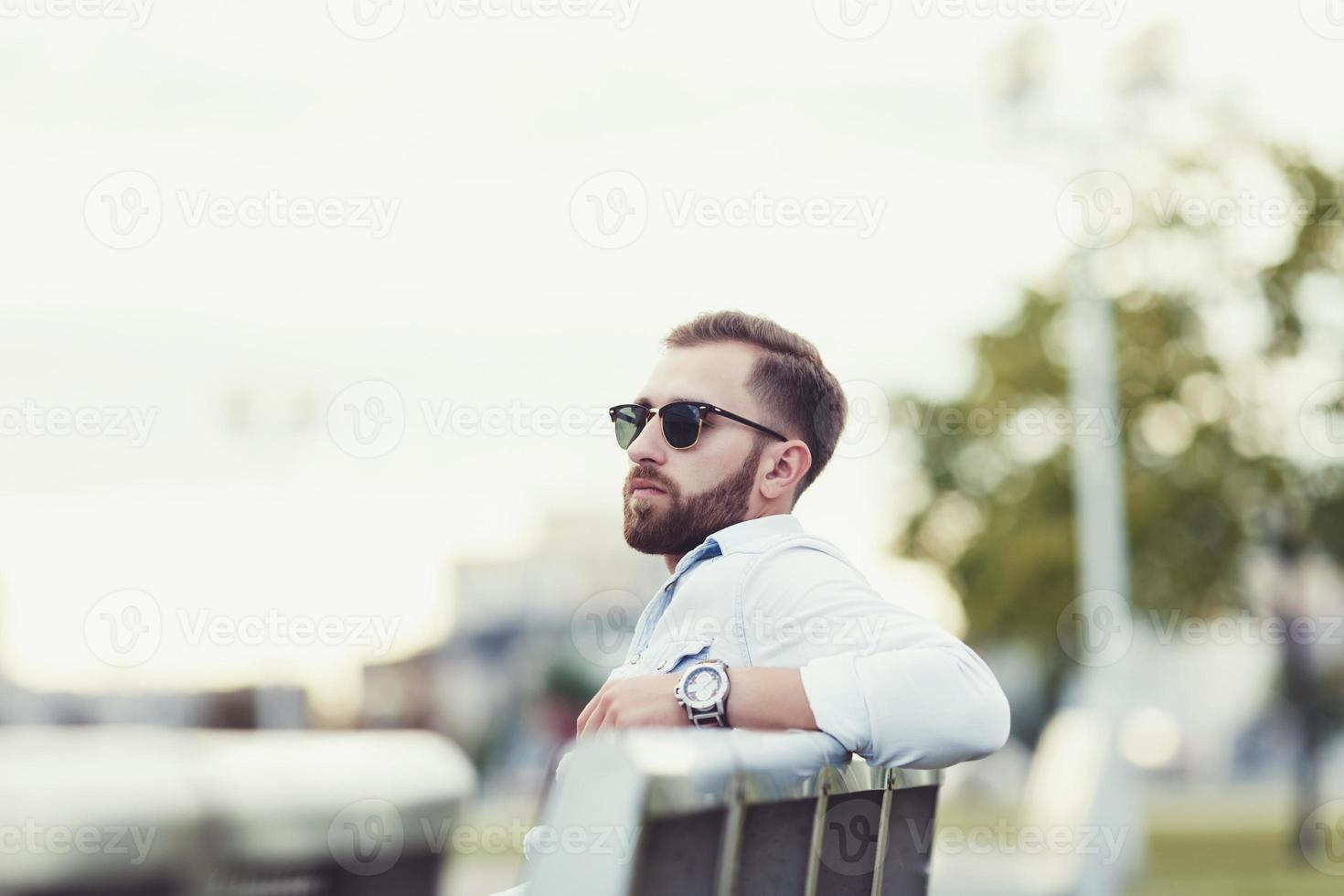 young man sitting on bench photo