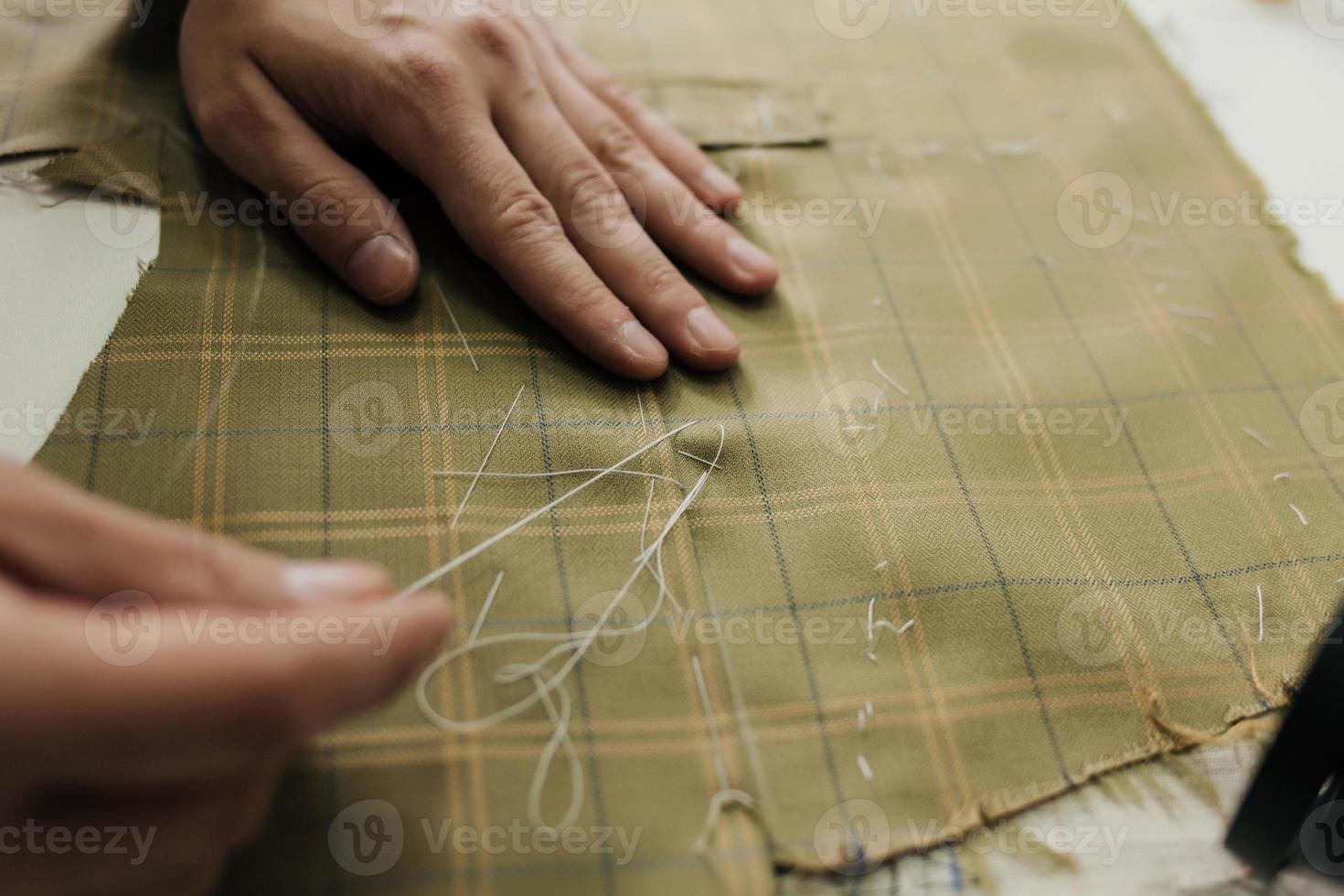 Tailor working with custom made suit photo