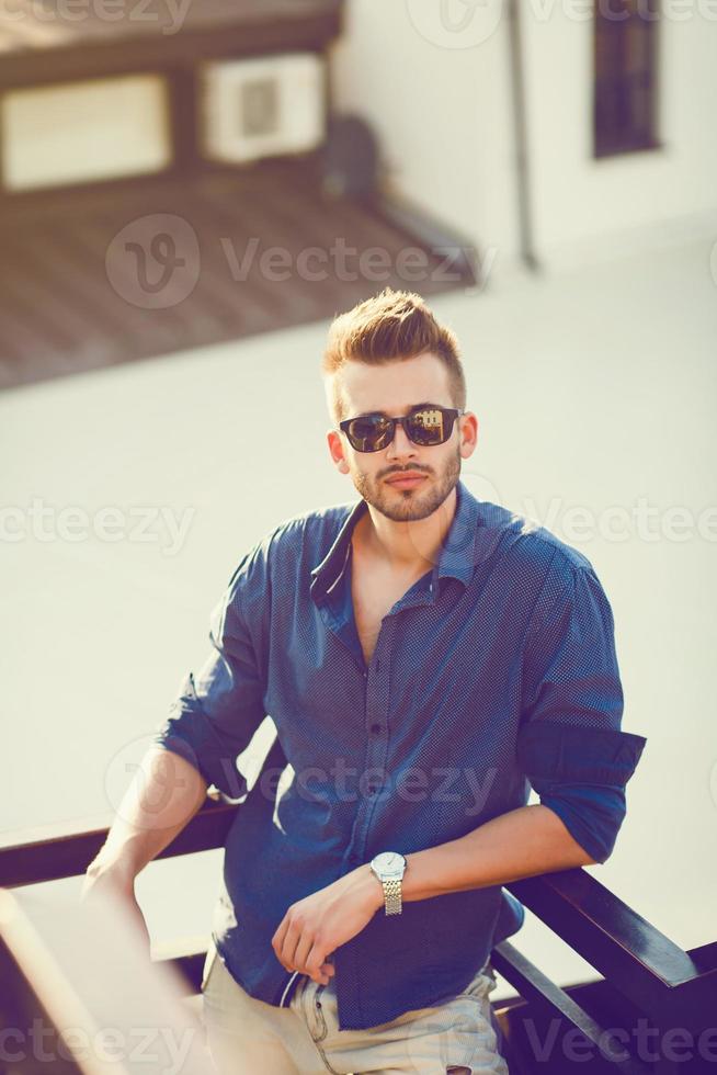 Young male model posing outdoors photo