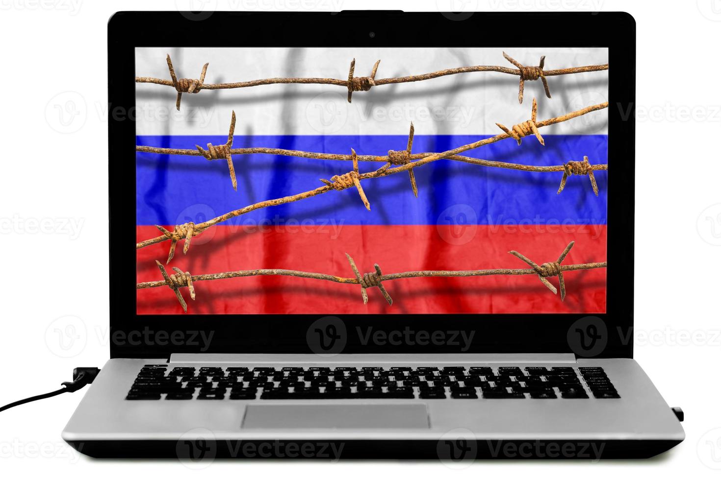 Isolated laptop with rusty barbed wire and the Russian flag on the screen. photo