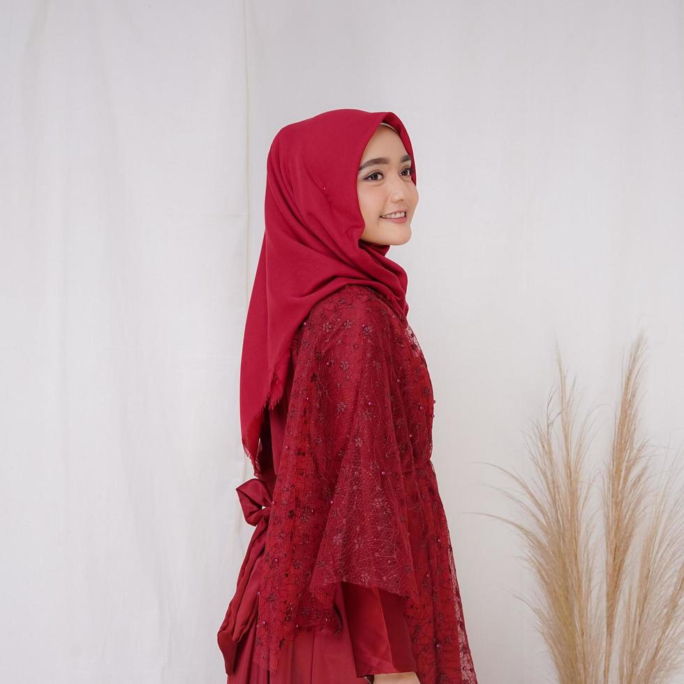 Beautiful islamic female model wearing hijab fashion, a modern lifestyle outfit for muslim woman. Concept a wedding dress, beauty or eidul fitri. A asian girl model wearing hijab on indoor photoshoot photo