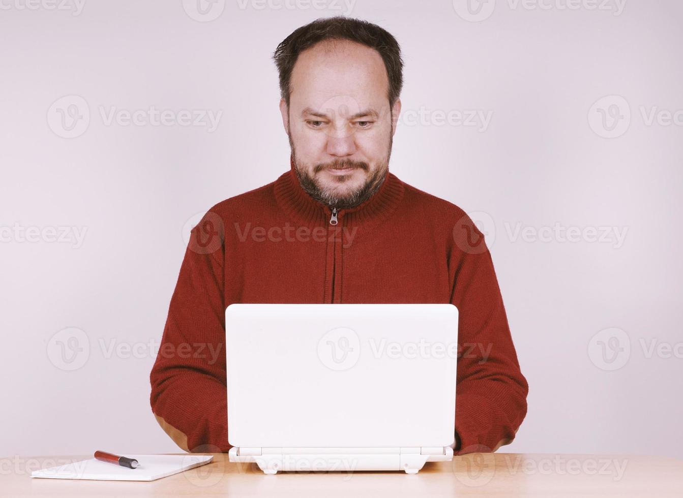 mid adult man using netbook notebook computer to stay connected photo