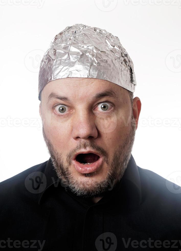 paranoid man wearing tin foil hat in shock photo