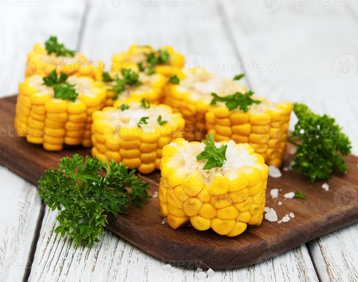 Board with boiled corn on the cob photo